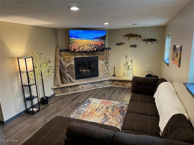2939 Lindale Dr, Akron, OH 44312 - living room with recessed lighting, baseboards, a stone fireplace, and wood finished floors