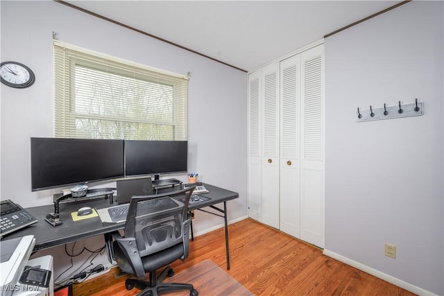 office area featuring baseboards and wood finished floors