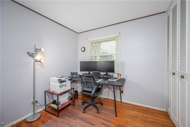 office space with baseboards and wood finished floors