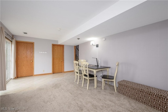 tiled dining space featuring carpet flooring and visible vents