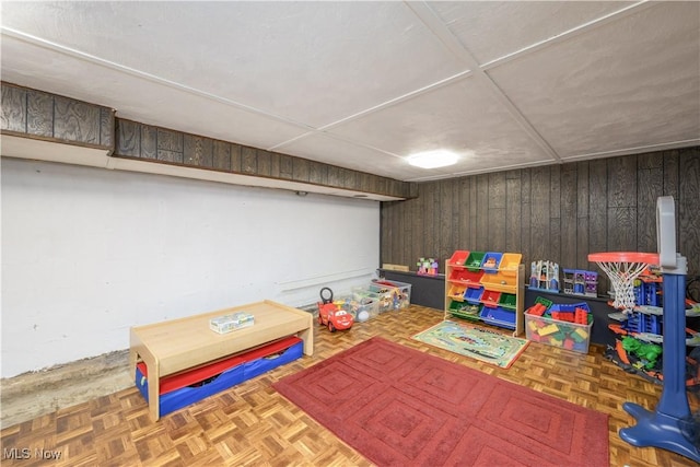 recreation room featuring wooden walls
