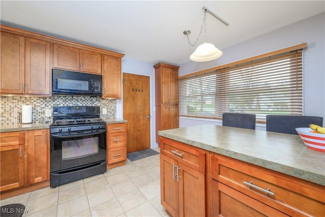 kitchen featuring brown cabinetry, decorative backsplash, light tile patterned floors, black appliances, and hanging light fixtures