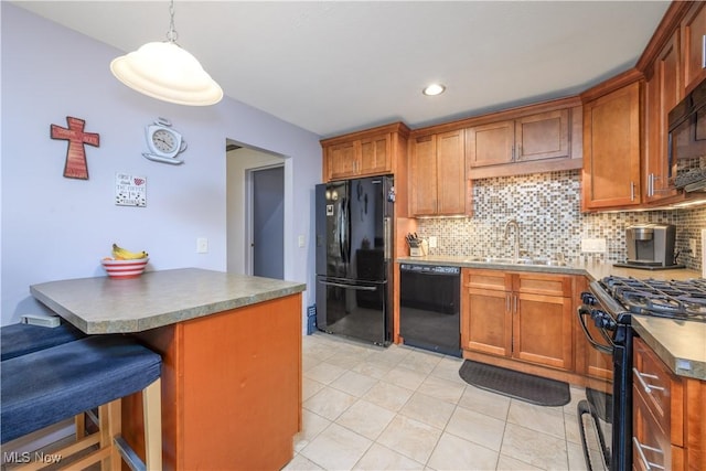 kitchen featuring light tile patterned floors, a sink, black appliances, and tasteful backsplash