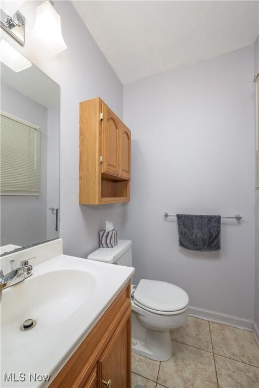 bathroom featuring vanity, tile patterned flooring, and toilet