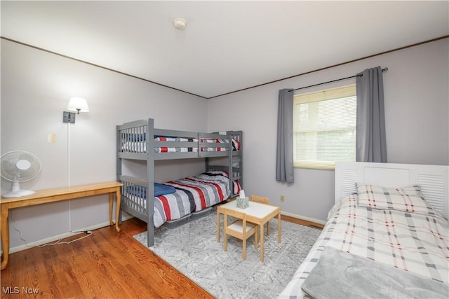 bedroom featuring baseboards and wood finished floors