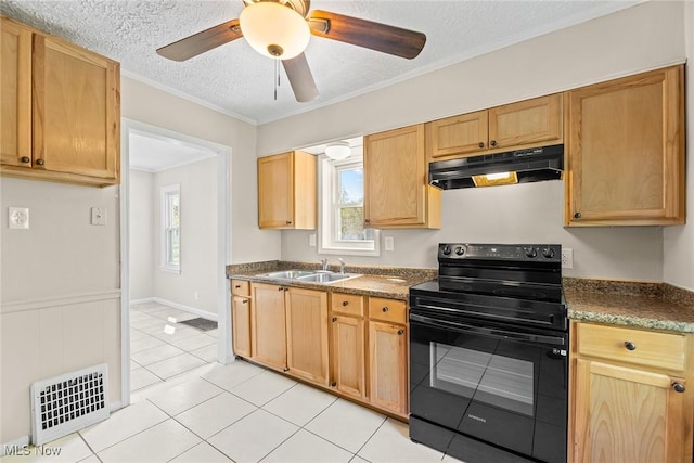 kitchen with visible vents, black electric range oven, under cabinet range hood, a sink, and light tile patterned floors