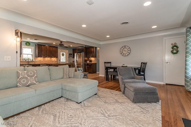 living area featuring ceiling fan, recessed lighting, wood finished floors, and visible vents