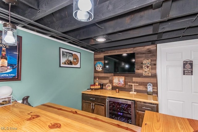 bar with indoor bar, beverage cooler, and wood walls