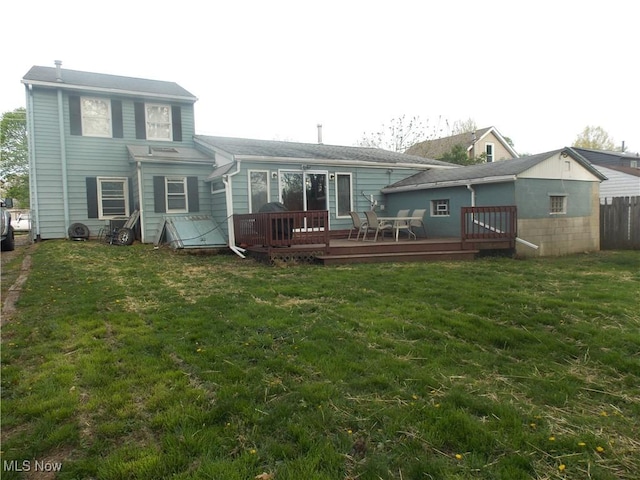 back of house with a lawn, fence, and a wooden deck