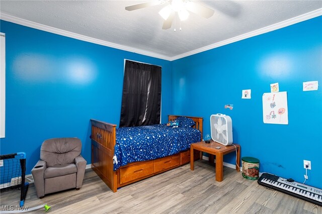 326 N Lyman St, Wadsworth, OH 44281 - bedroom with baseboards, ornamental molding, ceiling fan, and wood finished floors