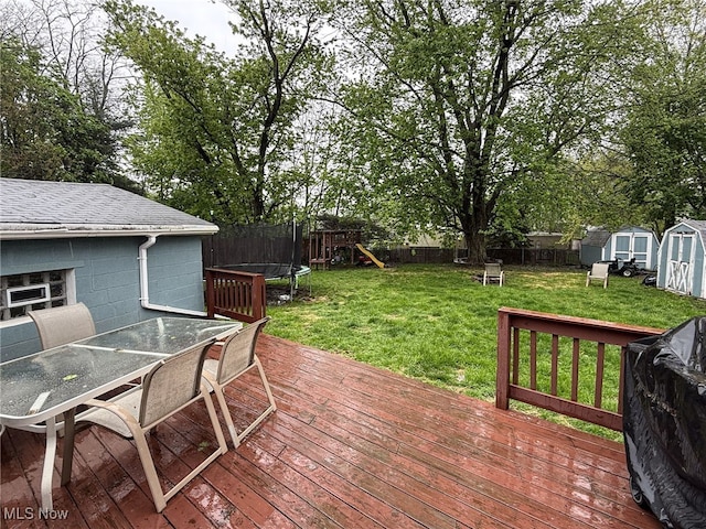 326 N Lyman St, Wadsworth, OH 44281 - deck featuring a fenced backyard, outdoor dining space, a shed, a trampoline, and a playground