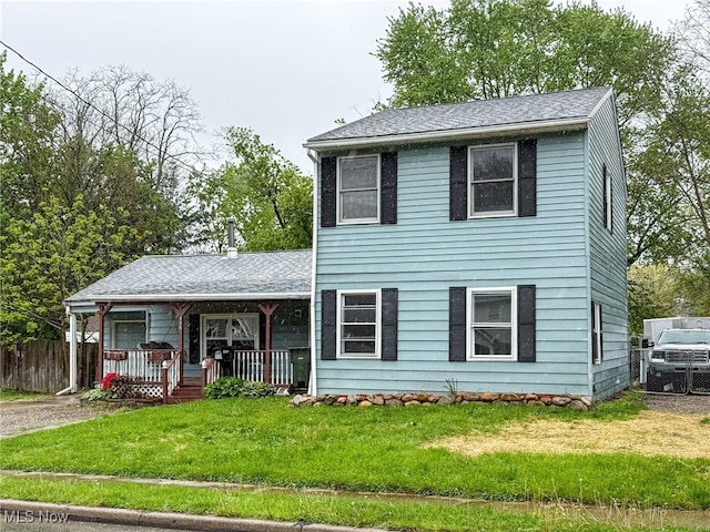 326 N Lyman St, Wadsworth, OH 44281 - view of front of house featuring a front yard, a shingled roof, covered porch, and fence