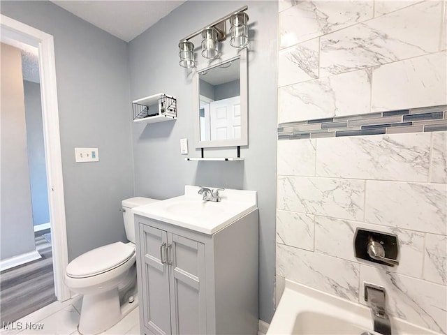 bathroom with vanity, baseboards, toilet, and marble finish floor