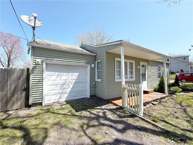 ranch-style home featuring aphalt driveway and fence