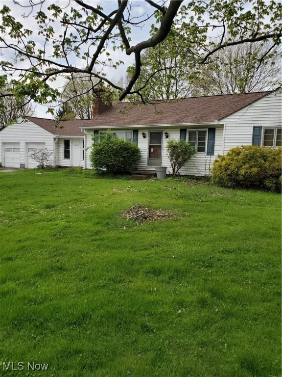 ranch-style house with a chimney and a front lawn
