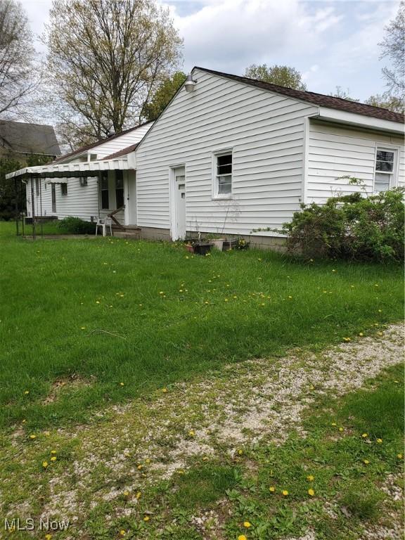 back of property with a lawn