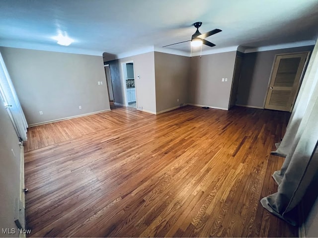 unfurnished bedroom featuring baseboards, a ceiling fan, and wood finished floors