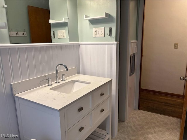 bathroom featuring vanity, wainscoting, and tile patterned floors