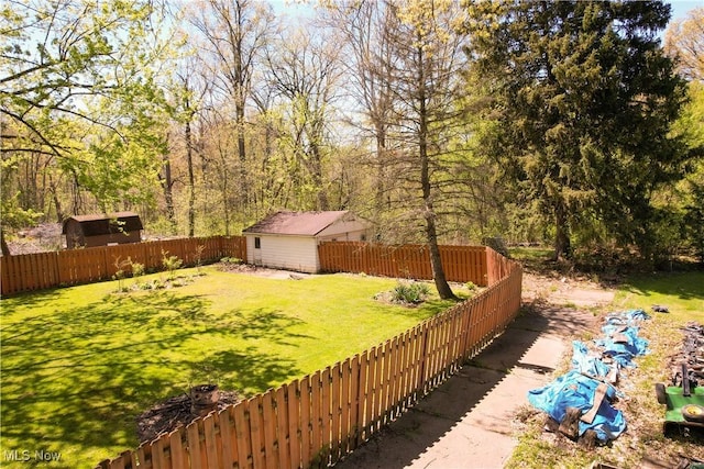 view of yard with an outdoor structure and a fenced backyard