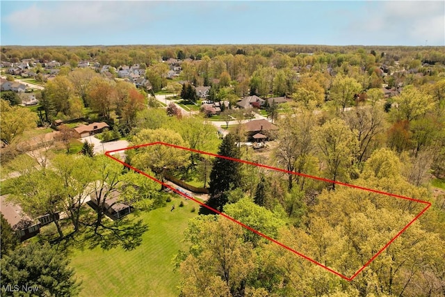 drone / aerial view featuring a forest view