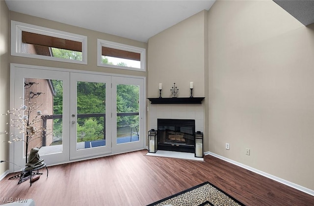 25078 Mill River Rd, Olmsted Falls, OH 44138 - living room with high vaulted ceiling, wood finished floors, a fireplace, and baseboards