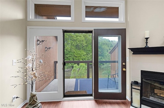25078 Mill River Rd, Olmsted Falls, OH 44138 - doorway to outside with a fireplace and wood finished floors