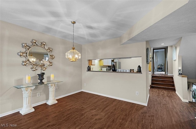 25078 Mill River Rd, Olmsted Falls, OH 44138 - unfurnished dining area with wood finished floors, baseboards, a chandelier, and stairway