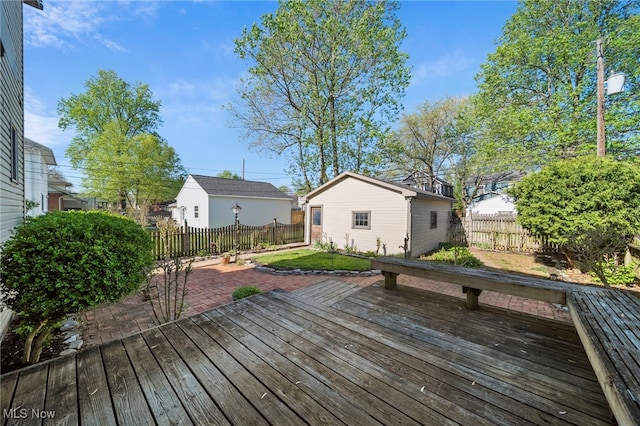 wooden deck featuring a fenced backyard and an outdoor structure