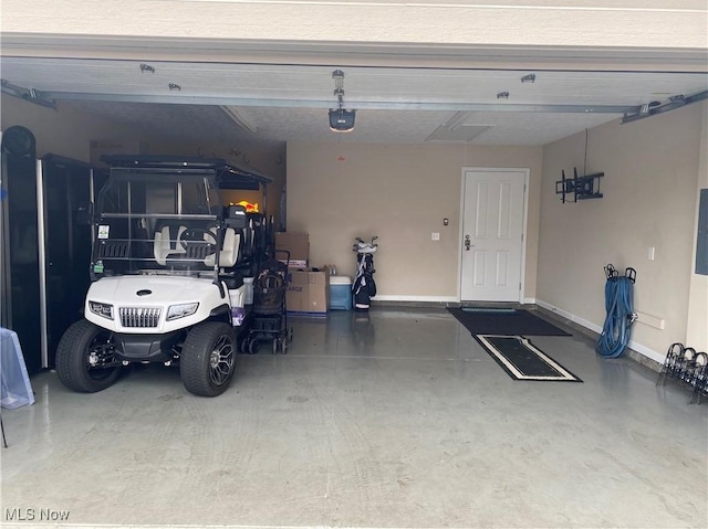 garage featuring baseboards and a garage door opener