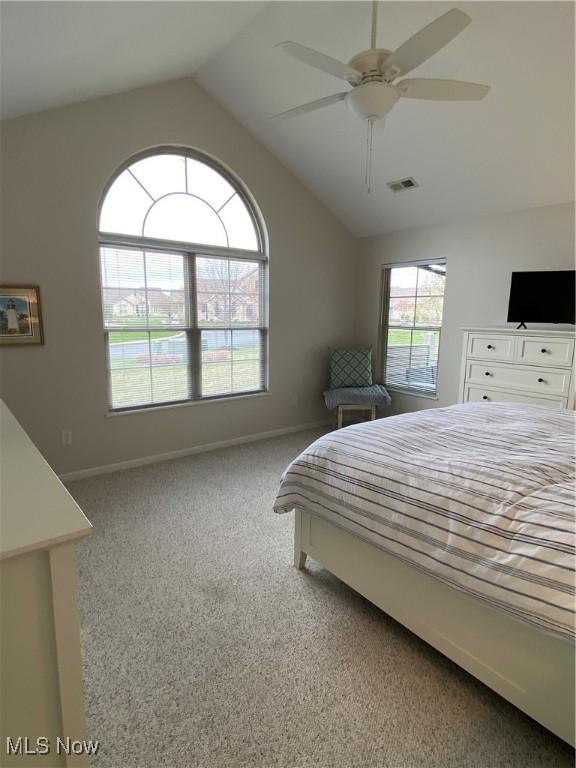 bedroom with baseboards, lofted ceiling, carpet flooring, and visible vents