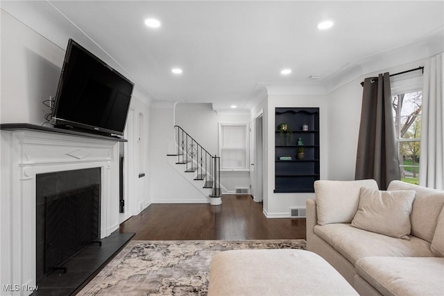living area featuring stairway, recessed lighting, dark wood-style floors, and visible vents