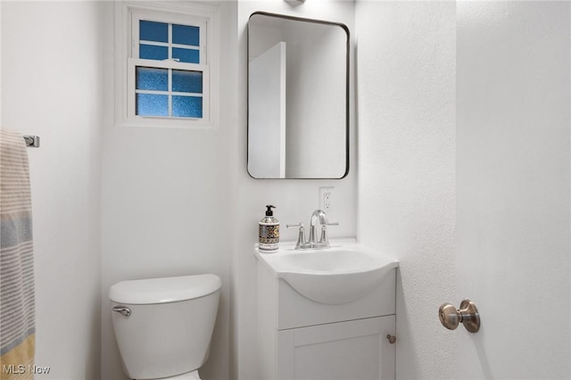 bathroom with toilet and vanity