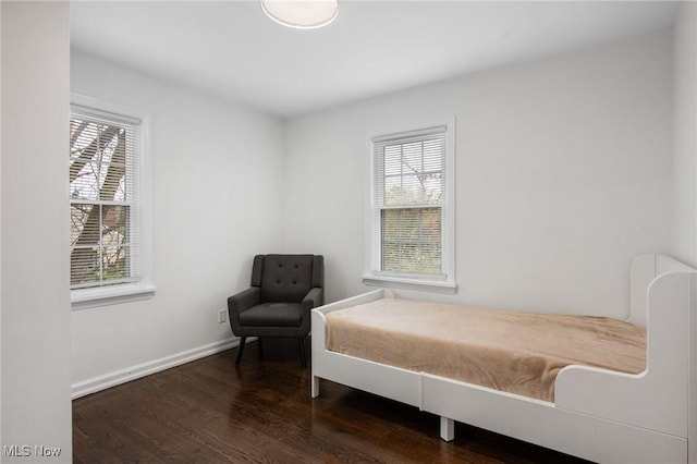 bedroom featuring baseboards and wood finished floors