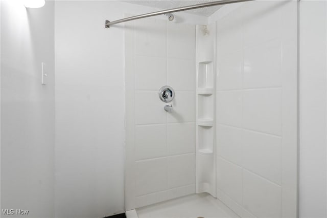 bathroom with a tile shower