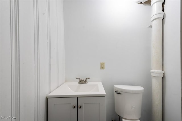 half bathroom featuring toilet and vanity