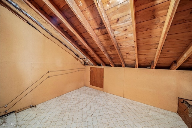 additional living space with beam ceiling, light carpet, and wooden ceiling