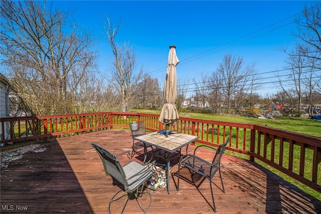 wooden terrace featuring outdoor dining space