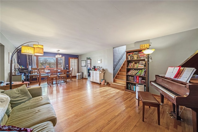 living area with light wood-style flooring and stairway