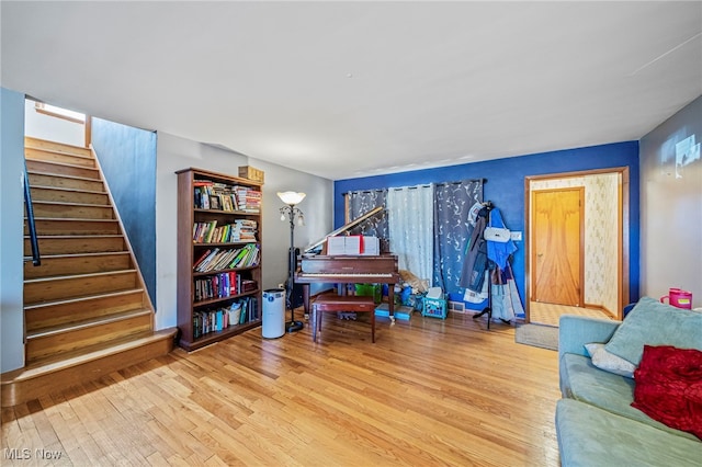 living area with stairs and wood finished floors