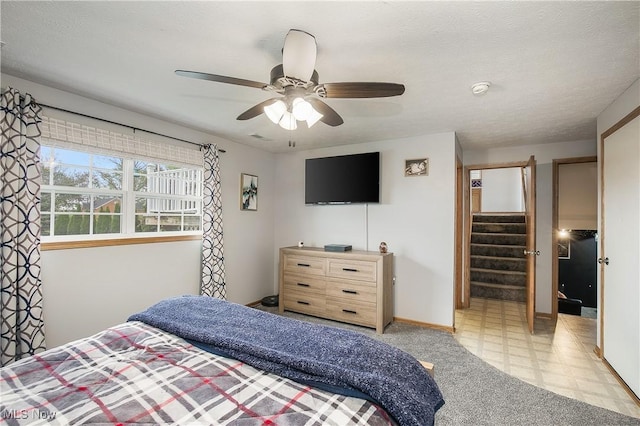 bedroom with baseboards and a ceiling fan
