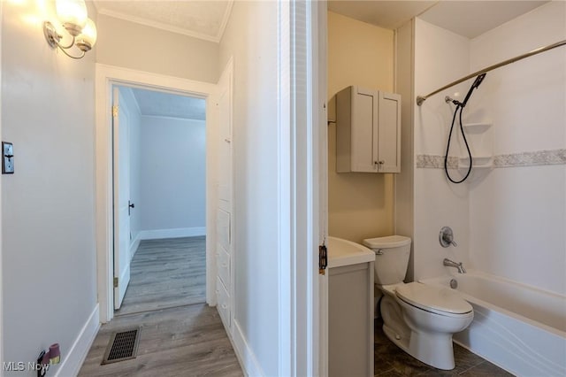bathroom featuring shower / bathing tub combination, visible vents, wood finished floors, toilet, and ornamental molding