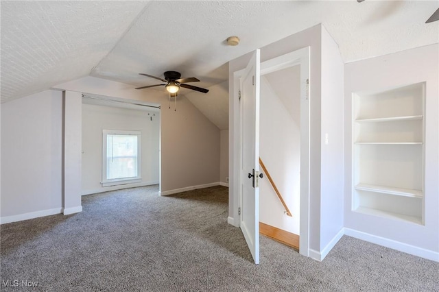 bonus room featuring baseboards, a ceiling fan, vaulted ceiling, and carpet flooring