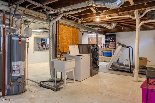unfinished below grade area featuring gas water heater and washer and dryer