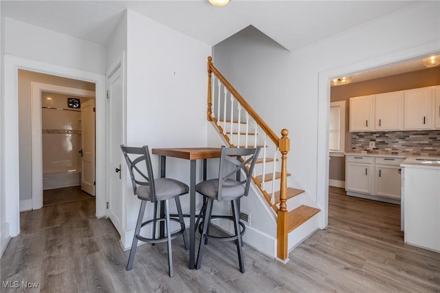 interior space with baseboards and wood finished floors