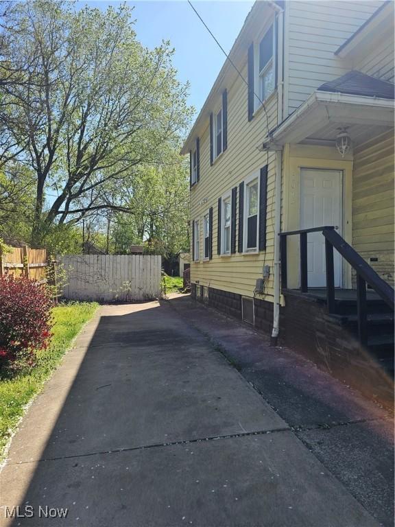 view of side of home with fence