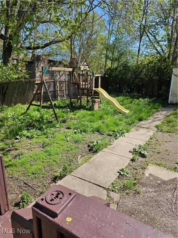 view of yard with a playground and fence