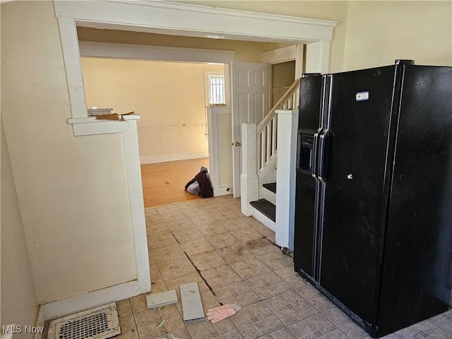 kitchen featuring visible vents and black fridge