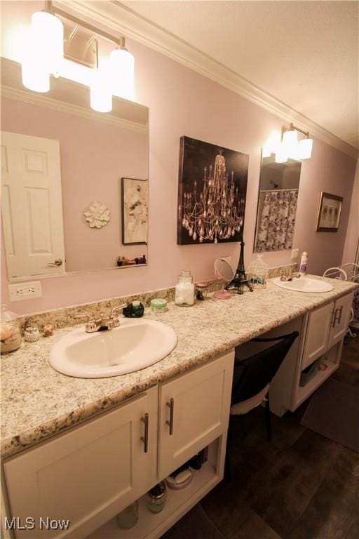 full bathroom with crown molding, double vanity, and a sink