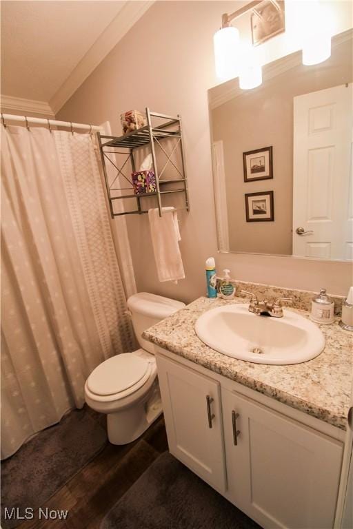 bathroom with crown molding, vanity, toilet, curtained shower, and wood finished floors