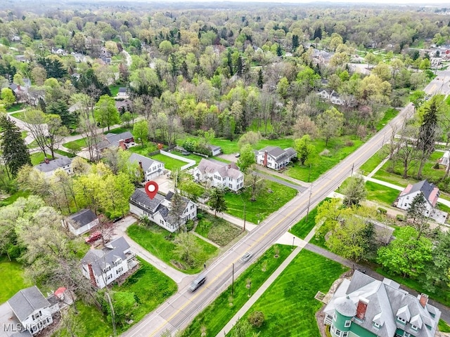 aerial view featuring a wooded view and a residential view